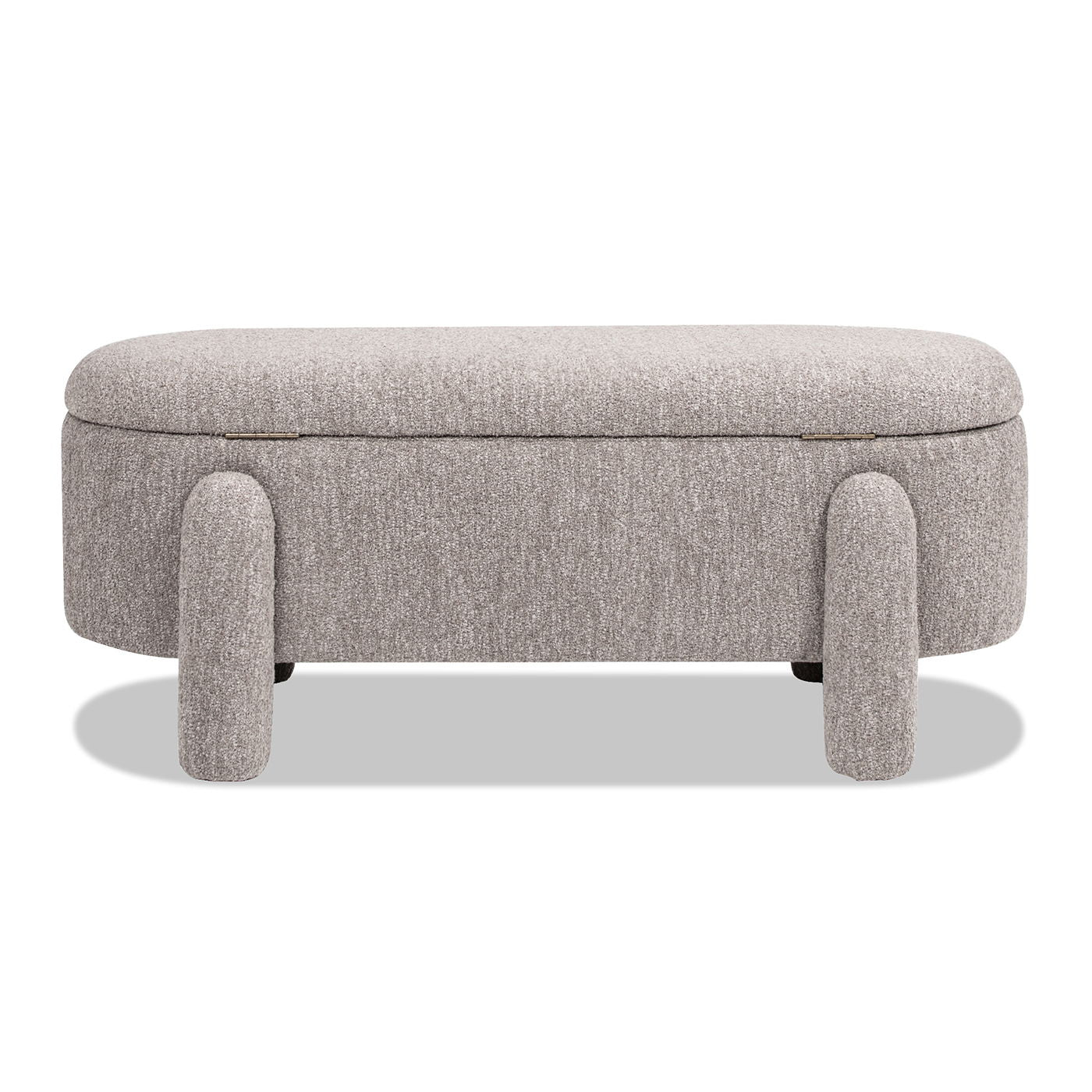 The Hugo - Oval Fully Upholstered Storage Bench features a modern oval design, light gray fabric, and four thick cylindrical legs. It is shown against a white background with a shadow underneath.