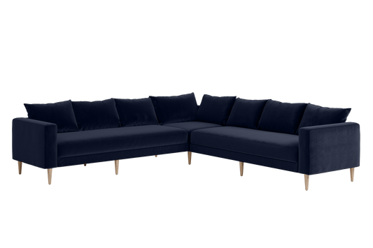 The Essential Corner Sectional (7 Seat) features a dark blue velvet upholstery and wooden legs in an L-shaped design.