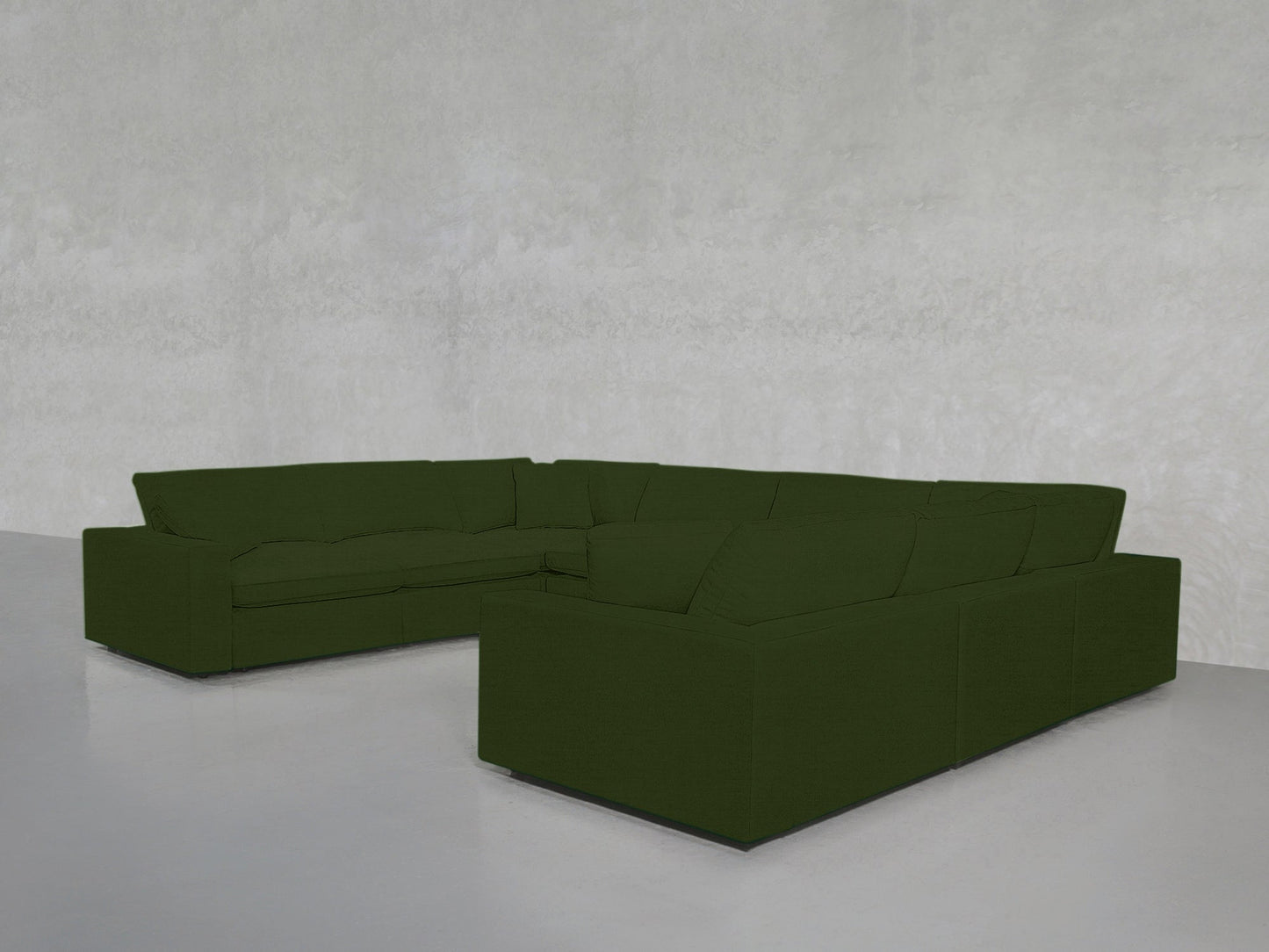 An 8-Seat Modular U-Sectional in dark green with clean lines is placed in an empty room featuring light gray walls and a glossy light gray floor.