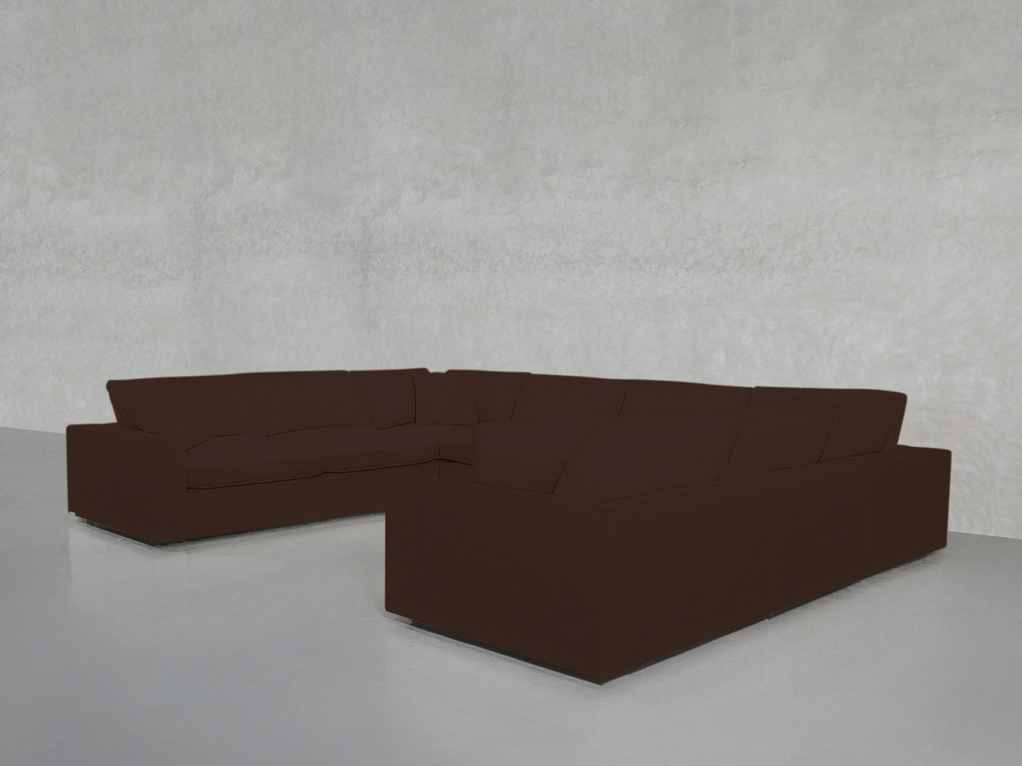 An 8-Seat Modular U-Sectional in dark brown is arranged in a minimalist room featuring light gray walls and a smooth, light-colored floor.