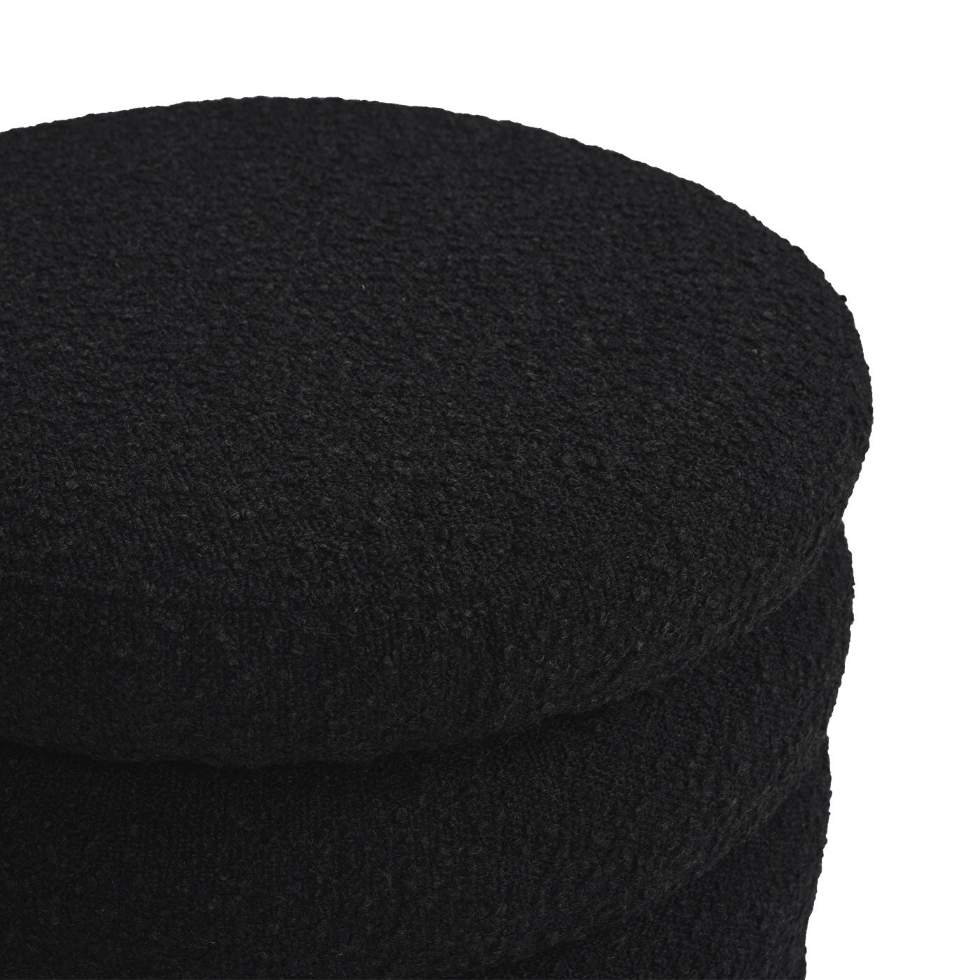 A close-up view of three stacked Fuji Oversized Round Storage Ottomans in black, showcasing their textured finish against a white background.