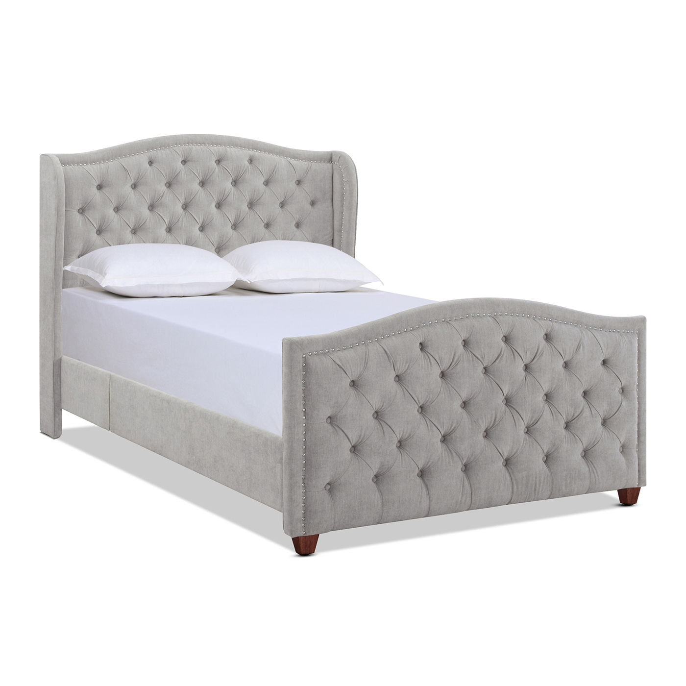 The Marcella Upholstered Shelter Headboard Bed Set features a gray, high tufted headboard and matching footboard with diamond-pattern button details. It’s shown neatly made with white bedding and pillows.