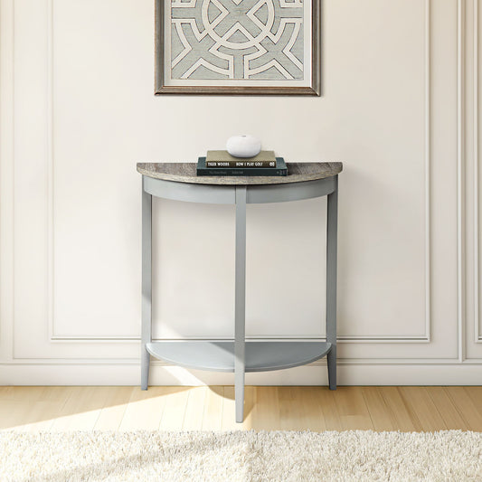 The Justino - Console Table in gray/oak with a stone top stands against a white wall, holding three books and a round white object. Framed art hangs above, while a cream rug covers the light wood floor beneath.