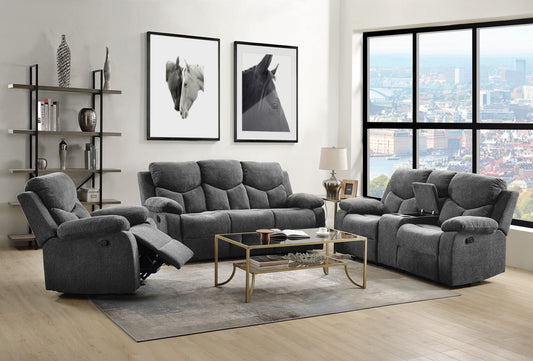 A modern living room with the Kalen Chenille 3 Piece Recliner Living Room Set in gray, a glass coffee table, beige rug, decorative shelves, framed horse art on the wall, and large windows revealing a cityscape view.