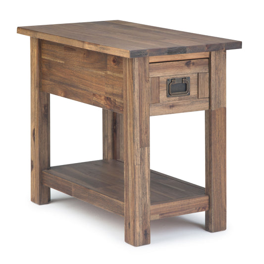 The Monroe - Handcrafted Side Table features a natural wood finish, a lower shelf, and a small drawer with a metal handle. Its simple rustic design is highlighted against a white background.