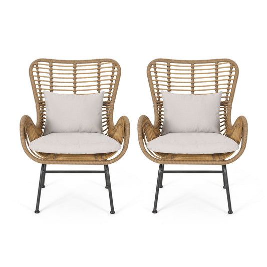 Set of two Modern Aesthetic Outdoor Rattan Accent Chairs with high backs, curved armrests, light beige seat cushions, matching throw pillows, and black metal legs for a stylish, airy look.