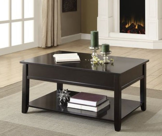 The Malachi Coffee Table With Lift Top in black sits on a rug in a living room with a fireplace, window, and curtains, topped with two green candles, a book, and decorative items.