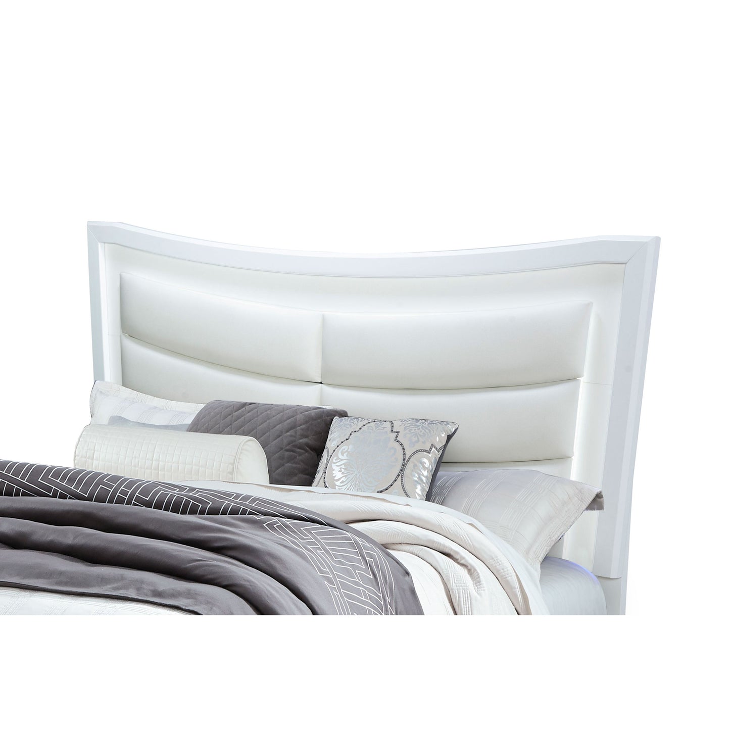 The Maloise - Bed features a modern white upholstered headboard with a curved design, styled with decorative pillows and bedding in gray and white.