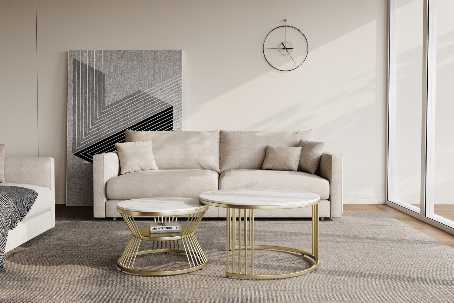 Minimalist living room with a beige sofa adorned with three cushions, a geometric artwork on the wall, and two round marble-top coffee tables with gold frames. A large window lets in natural light, illuminating the neutral-toned decor.