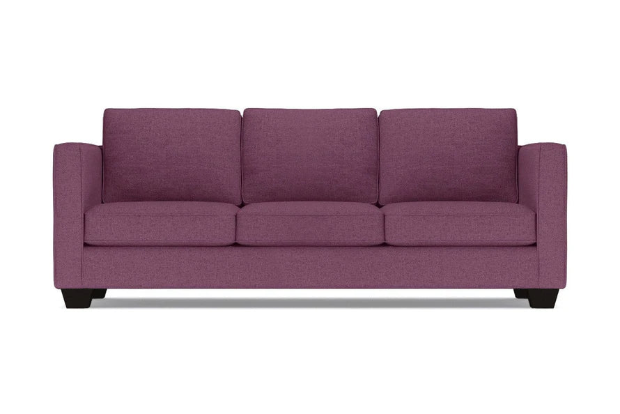 The Catalina Sofa is a three-seater in purple, featuring square arms and a modern design with three cushions and a low profile. It is displayed against a plain white background.