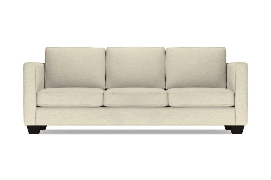 Introducing the Catalina Sofa: a three-seater in beige with square cushions and armrests, featuring black wooden legs, elegantly showcased against a white background.