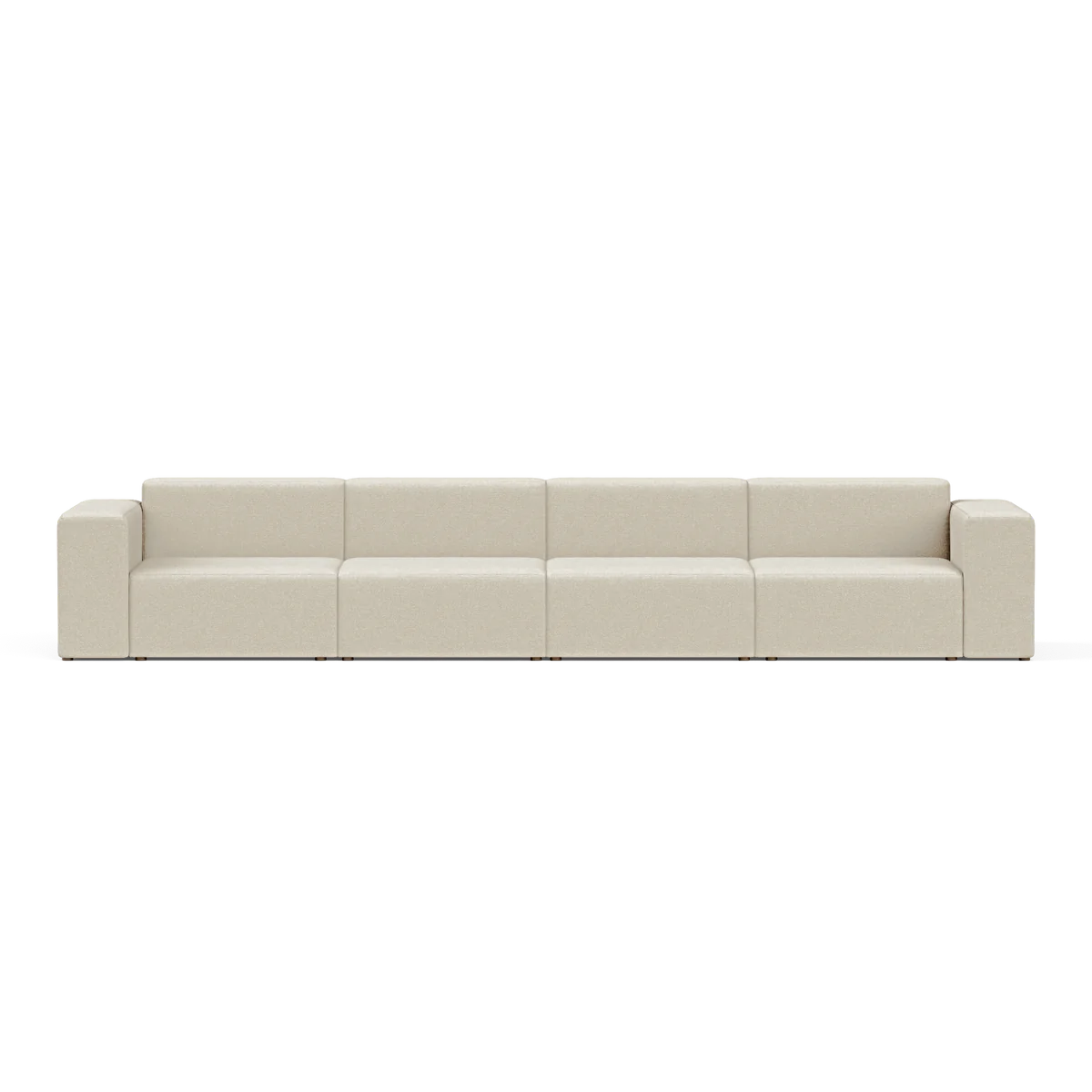 The Four-Seater Form Sectional is a long, beige modular sofa featuring four sections and square armrests. Set against a plain white background, it highlights its minimalist and contemporary design.