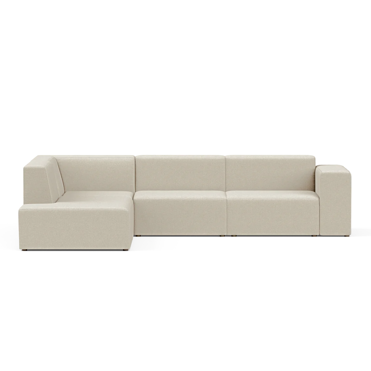 The Four-Seater Form Sectional is a modern, beige sofa featuring clean lines and a minimalist design. It includes a chaise lounge section on the left, all set against a plain, black background.