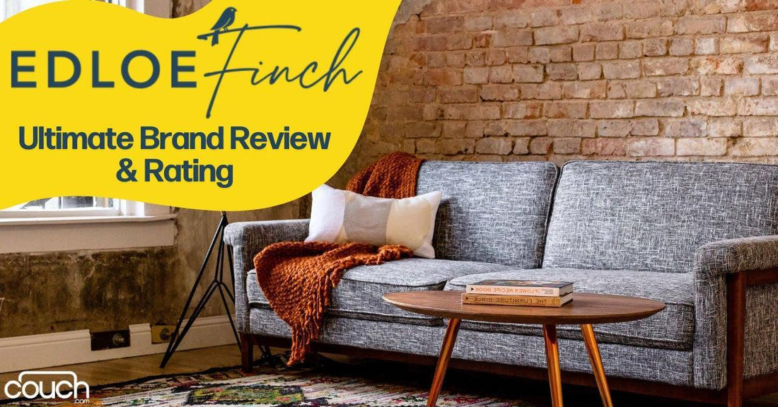 A cozy living room features a gray sofa with orange and white cushions and a throw blanket. A wooden coffee table holds a book. The wall has exposed bricks. Text reads: "Edloe Finch Ultimate Brand Review & Rating" with a bird icon.