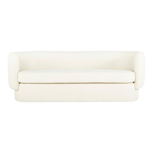 Introducing the Koba Sofa: A simple white sofa boasting curved armrests and a sleek, minimalistic design. This piece offers a smooth, cushioned surface and is placed against a plain white background.