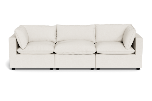 The Kova Pillow Cushion Sofa 122" is a modern, three-seat beige fabric sofa with plush cushions, square armrests, and a low profile, displayed against a plain black background.