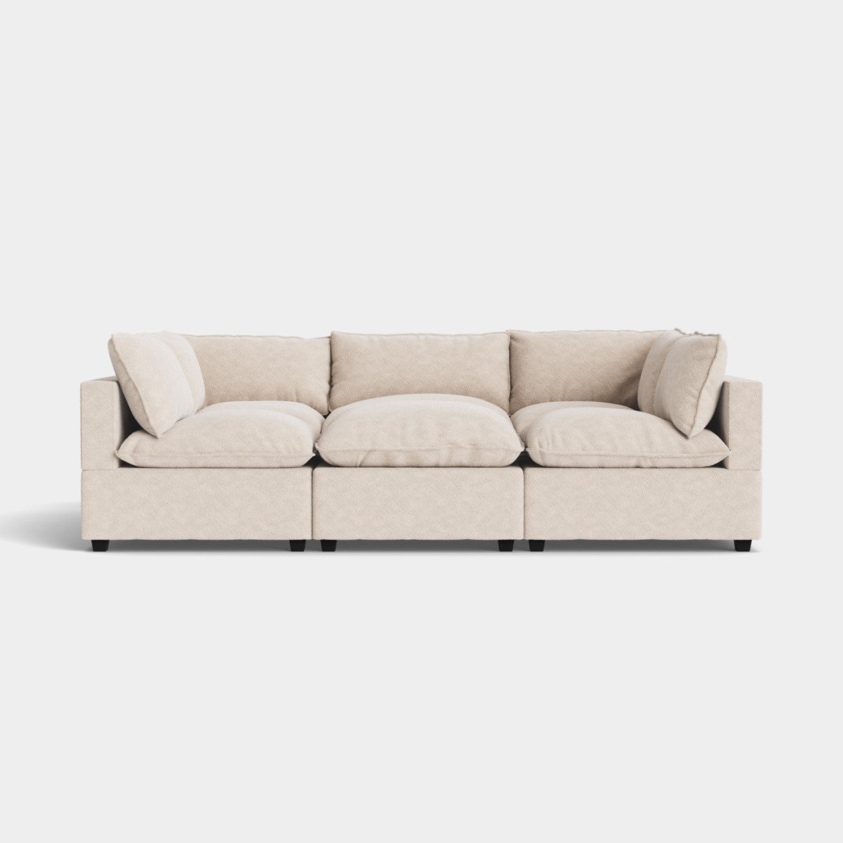 The Kova Pit is a beige modular sofa with three sections and plush cushions, positioned against a plain white background. It boasts clean lines and a contemporary design.