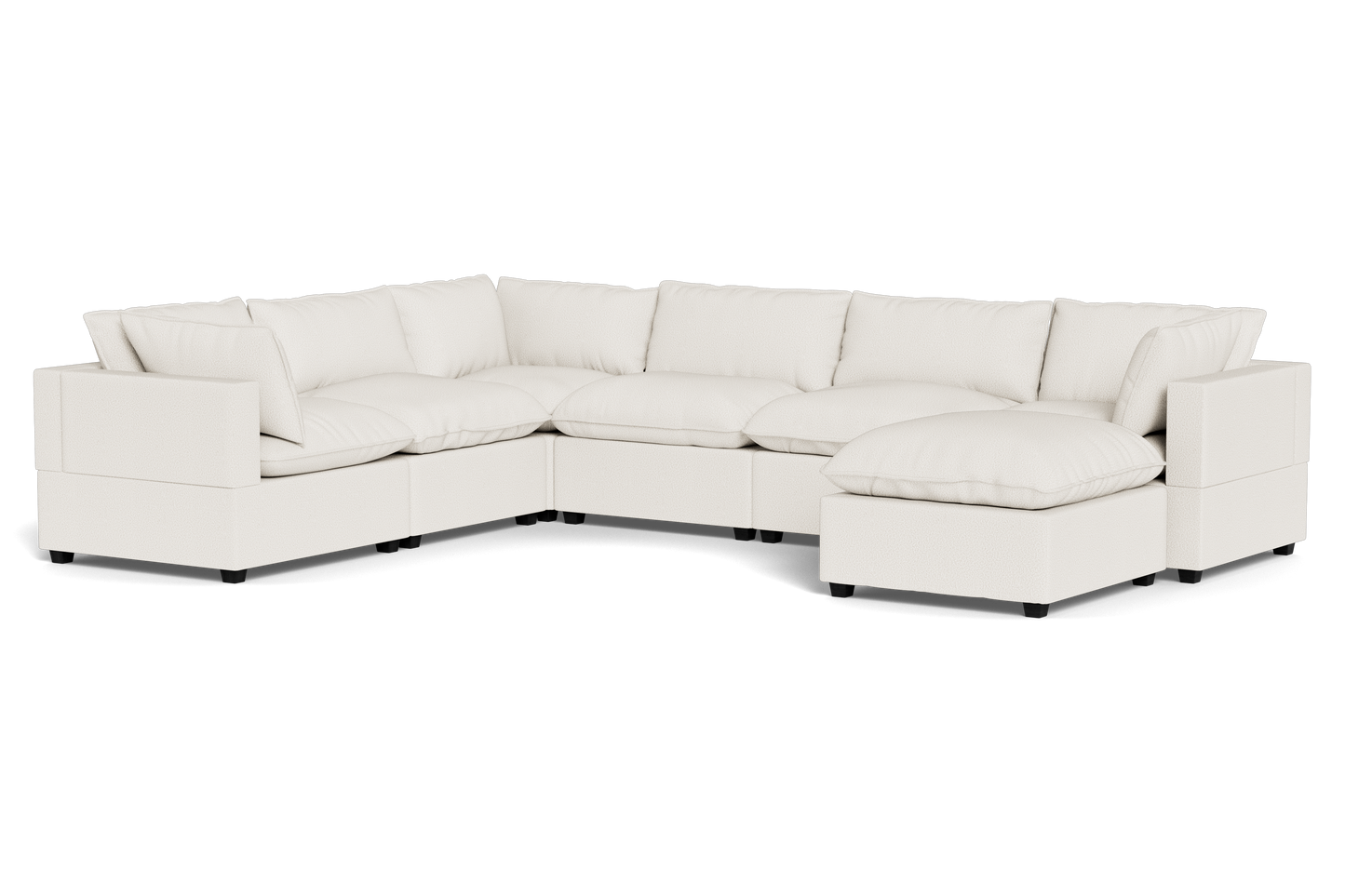 The Kova Pillow Cushion Grand Corner + Ottoman is a spacious, modern, off-white sectional sofa with plush cushions and an L-shaped design featuring a chaise lounge, shown against a plain black background.