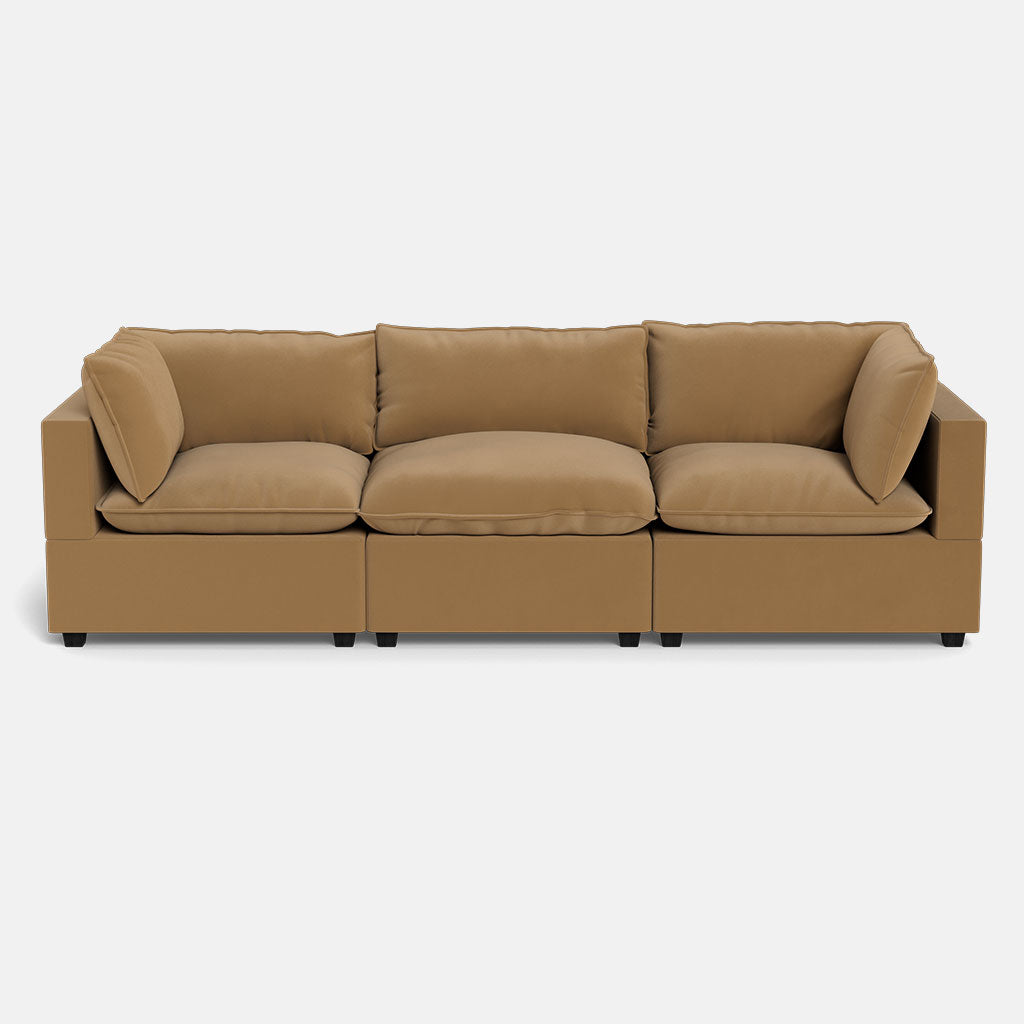 The Kova Pillow Cushion Sofa 122" is a modern tan three-seat sofa with square arms, three large seat cushions, and loose back and side cushions, shown against a plain white background.