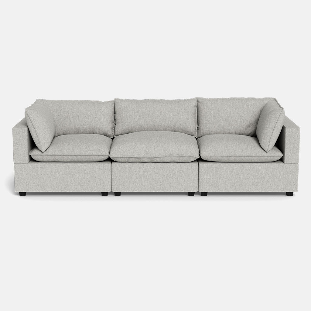 The Kova Pillow Cushion Sofa 122" is a modern, light gray three-seater featuring square arms and plush back and seat cushions, displayed against a plain white background.