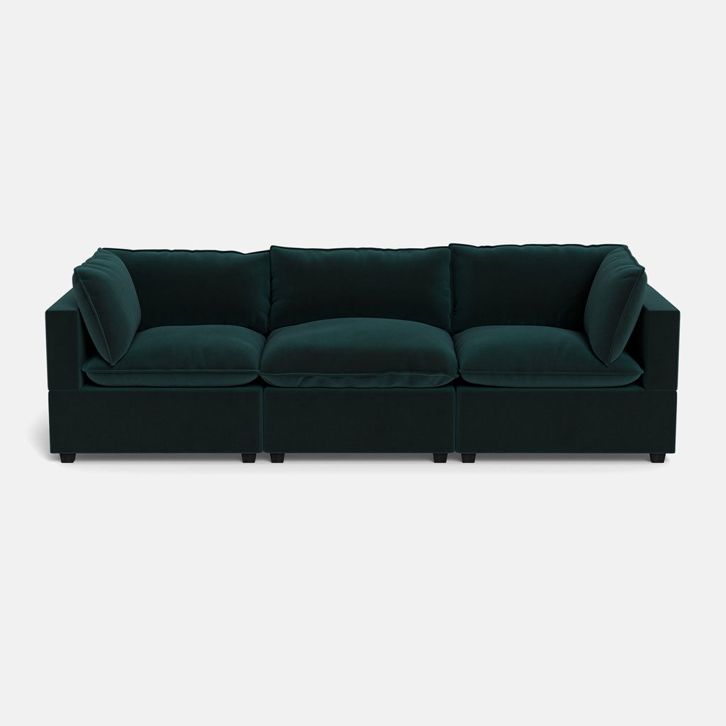 The Kova Pillow Cushion Sofa 122" is a modern deep green velvet sofa with three seat cushions, three back cushions, and wide armrests, shown against a plain white background.