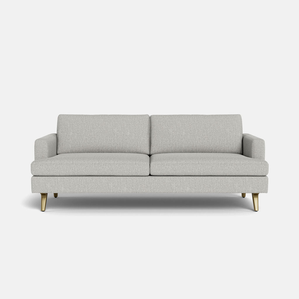 The Lido Sofa 75" features a modern light grey design with clean lines, two seat and two back cushions, low arms, and four angled wooden legs, set against a plain white background.