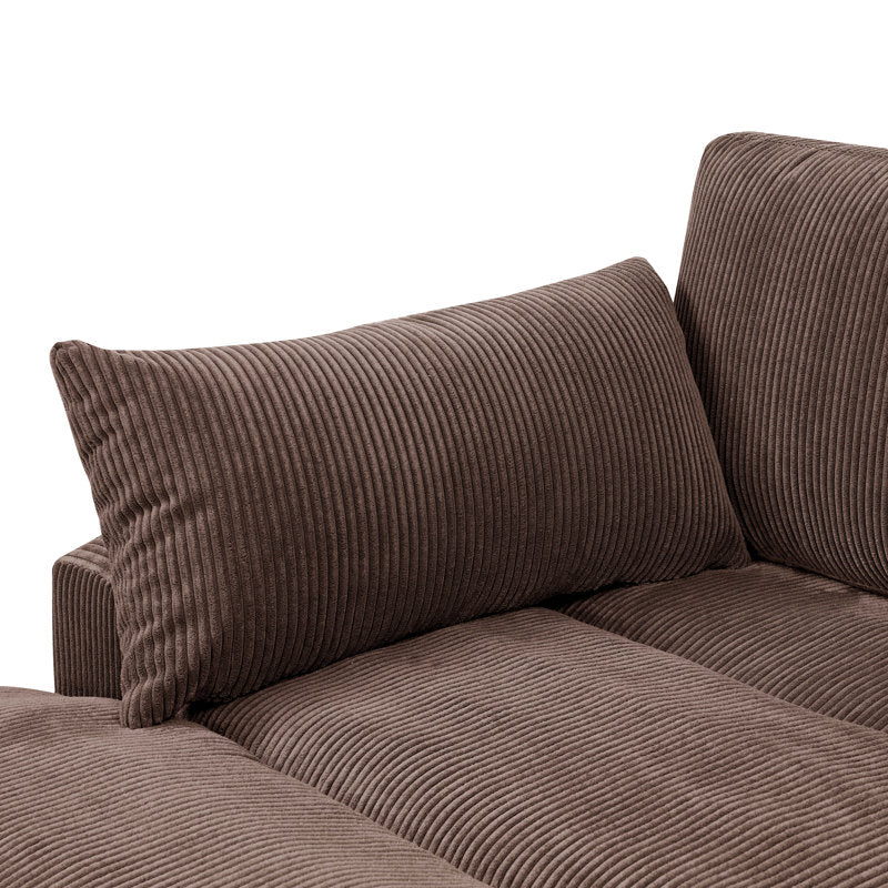Close-up of the Etta Avenue Mordecai 90'' Square Arm Sofa in brown corduroy with a matching cushion. The fabric exhibits a vertical ribbed texture, contributing to its cozy and plush look. The sofa features straight lines and a modern design.