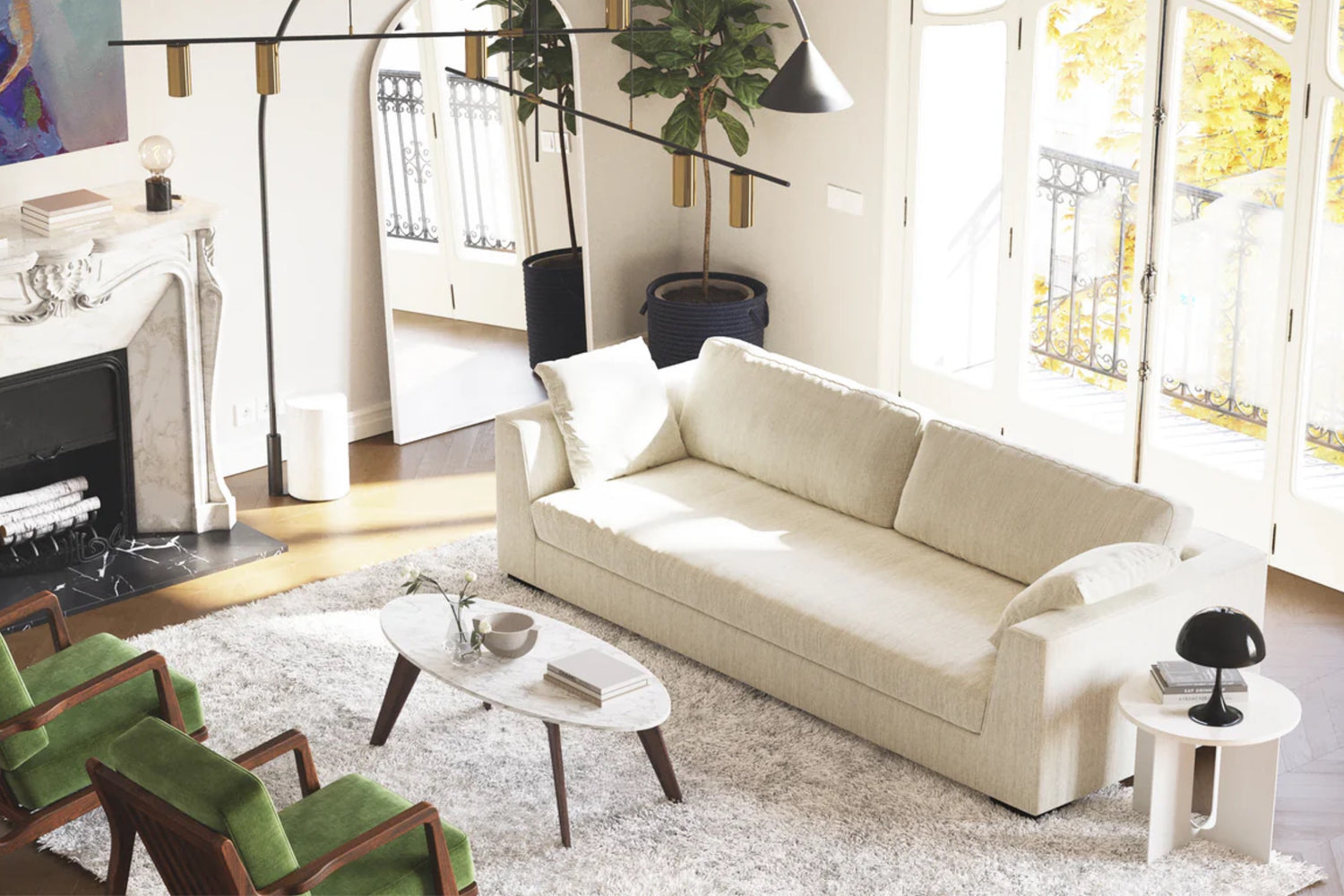 A bright, cozy living room with a cream-colored sofa on a plush white rug. A marble fireplace is on the left, and two green chairs face a wooden coffee table. Large windows let in natural light, illuminating the space with a warm ambiance.