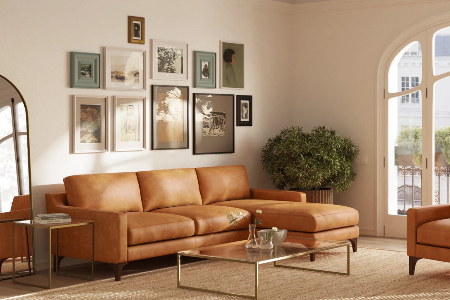 A cozy living room with a brown leather sectional sofa and a glass coffee table. The walls are adorned with a gallery of various framed artworks. A large potted plant sits nearby, and sunlight filters through an arched window.