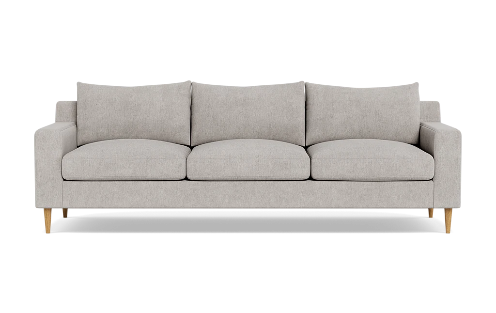 Introducing the Sloan Custom 3-Seat 95" Sofa, featuring a modern and minimalistic design with light gray upholstery. This three-seater has clean lines, cushioned backrests, and elegant wooden legs, all beautifully showcased against a plain black background.