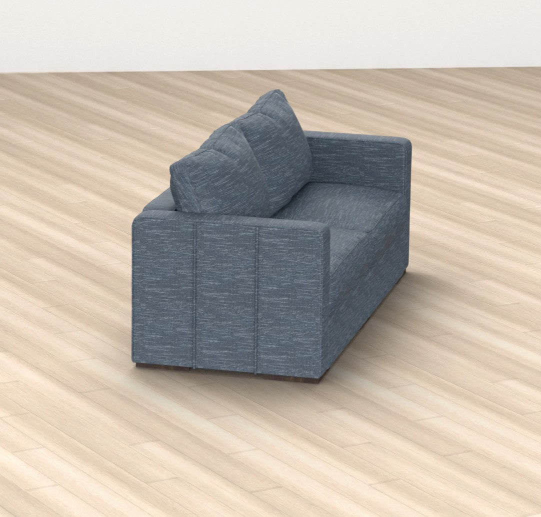 The Sactionals - 2 Seats + 4 Sides Vintage Blue Rained Chenille, featuring a modern, boxy design, is placed on a light wood floor. The small blue-gray sofa with two cushions is viewed from an elevated angle and is positioned to face slightly away from the camera.