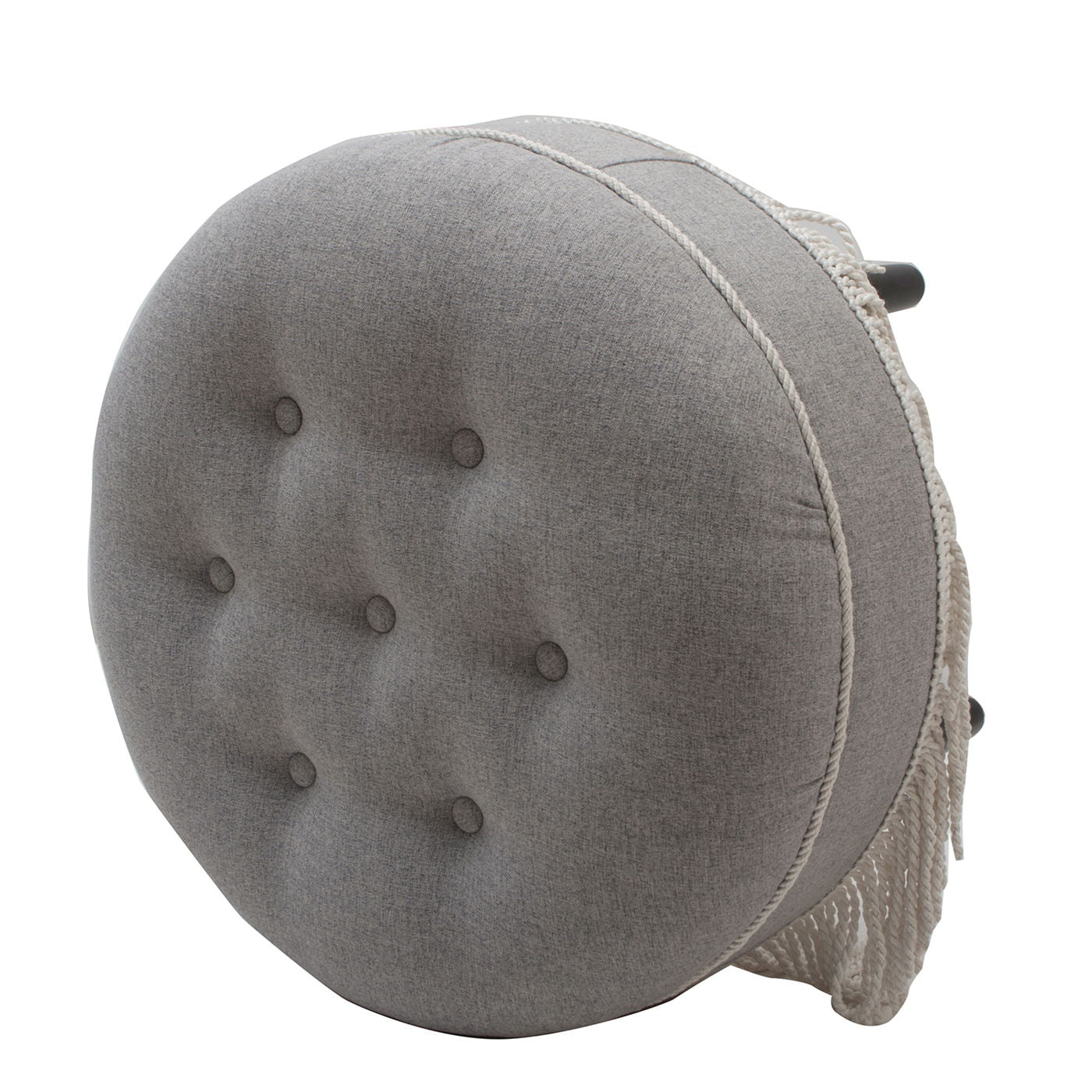 The Yolanda Round Upholstered Accent Ottoman is a gray, tufted cushion with buttons and white rope tassels on the side, perfect as a modern floor pillow or seat cushion.