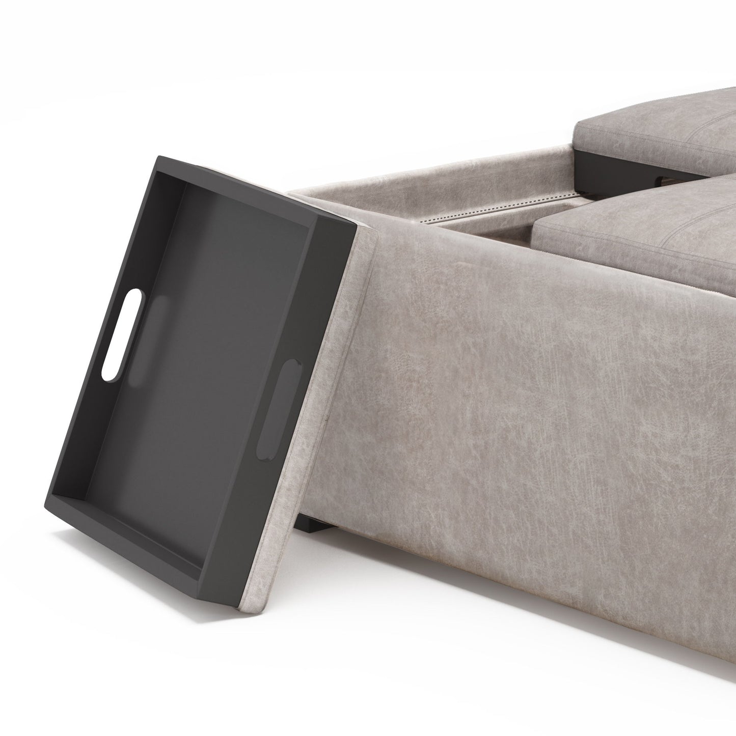 A close-up of the Avalon Square Coffee Table Storage Ottoman in light gray, featuring an open black tray resting against it and displaying its storage compartment and detailed cushion.