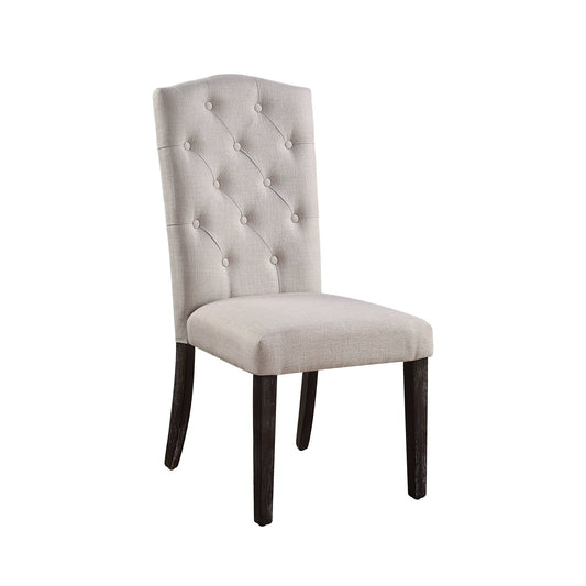 The Gerardo Linen Weathered Dining Chair (Set of 2) in beige features a tufted, buttoned backrest and dark wooden legs, upholstered in light beige fabric and displayed against a white background.