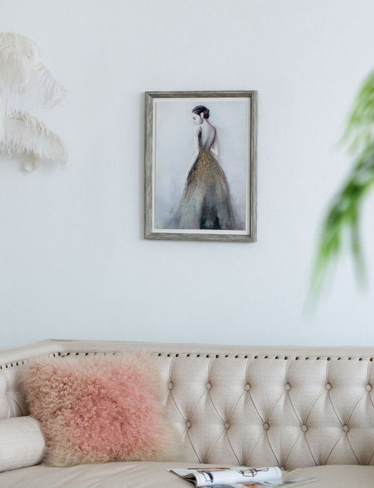 A beige tufted sofa with a pink pillow sits against a white wall. Above it hangs the Feminine Figure Wall Art, Wall Decor For Living Room Dining Room Office Bedroom - Multicolor. Green leaves and white feathers are visible in the foreground.