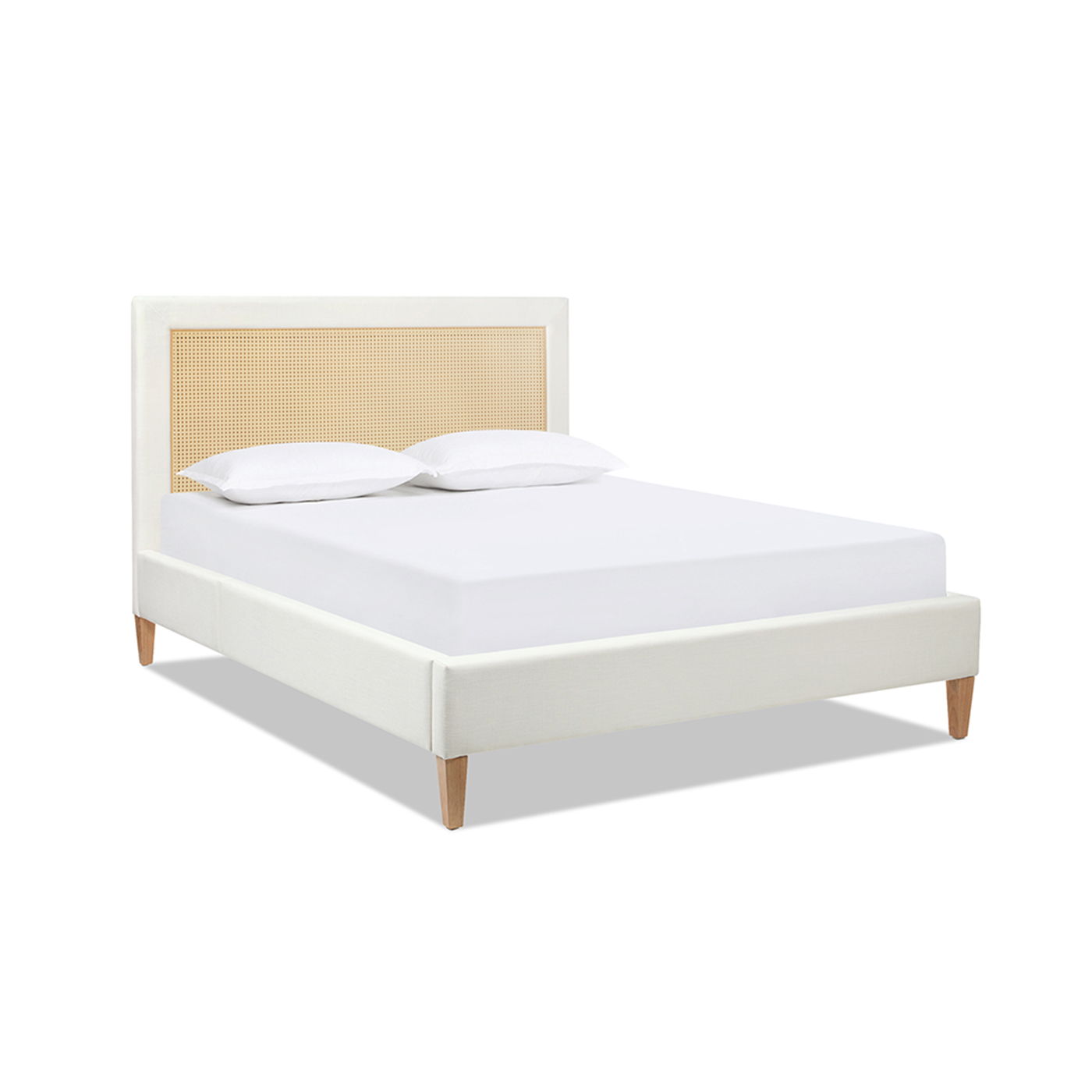 The Haley - Upholstered Cane Back Platform Bed features a modern light-colored frame, woven rattan headboard, wooden legs, and comes styled with two white pillows on a white mattress.
