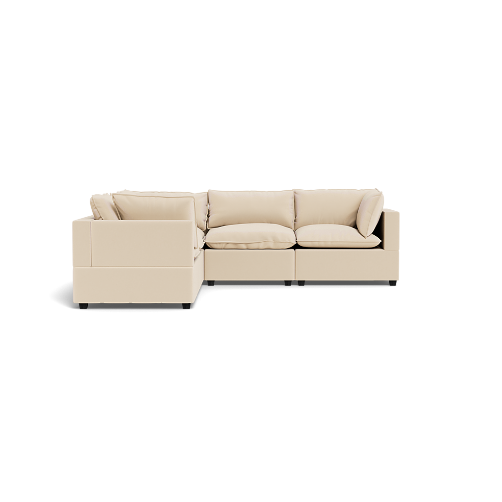 The Kova Pillow Cushion Corner Sectional is a beige L-shaped sofa with plush cushions and armrests, displayed against a plain white background.