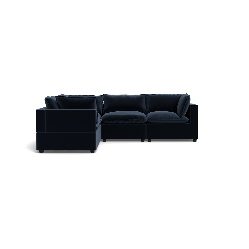 The Kova Pillow Cushion Corner Sectional is a modern, dark L-shaped sofa with plush cushions, shown against a plain black background.