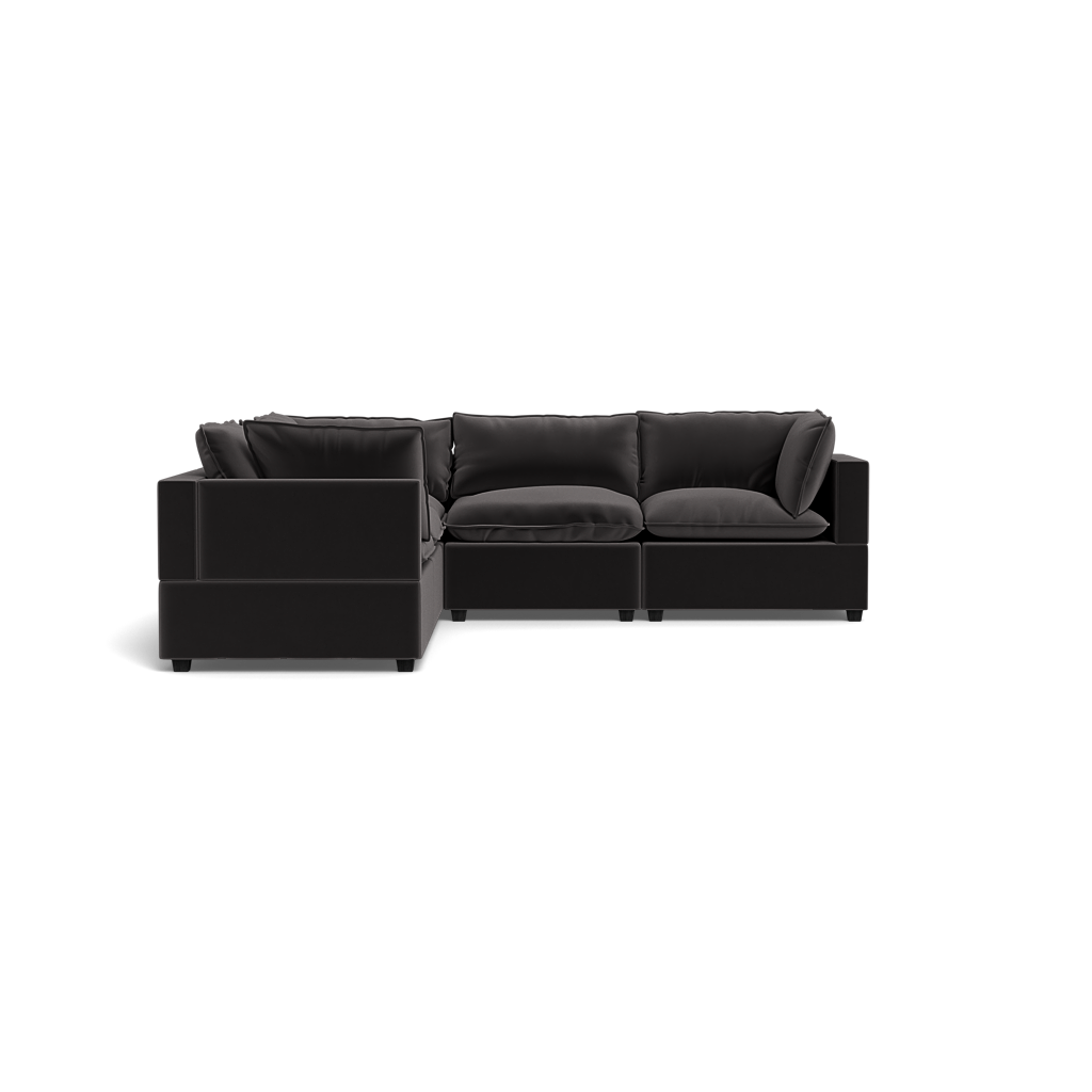 The Kova Pillow Cushion Corner Sectional, a modern black sofa with plush cushions and a left-facing chaise lounge, is shown against a plain black background.