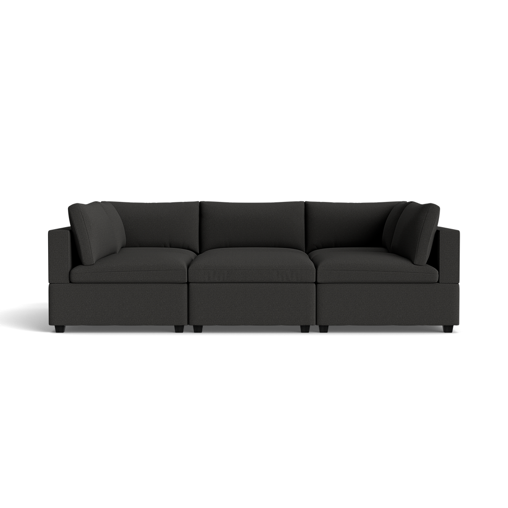 The Kova Box Cushion Pit is a modern, dark gray sectional sofa with three large seat cushions, plush backrest cushions, and square armrests for a minimalist look, shown against a black background.