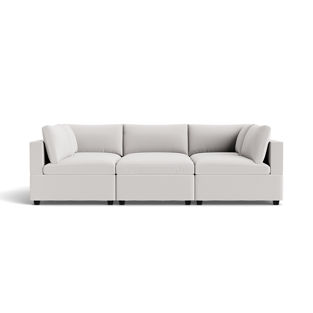 The Kova Box Cushion Pit is a modern, light gray sectional sofa with three main seating sections and plush backrest cushions, displayed against a plain white background.