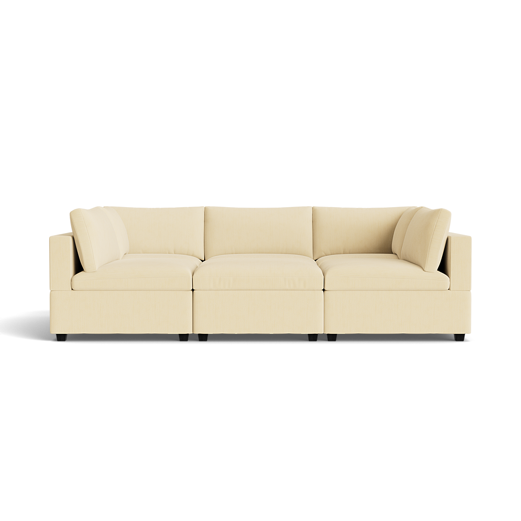 The Kova Box Cushion Pit is a modern cream-colored sectional sofa with three main seats, low backrests, straight armrests, and black square legs, displayed against a plain white background.