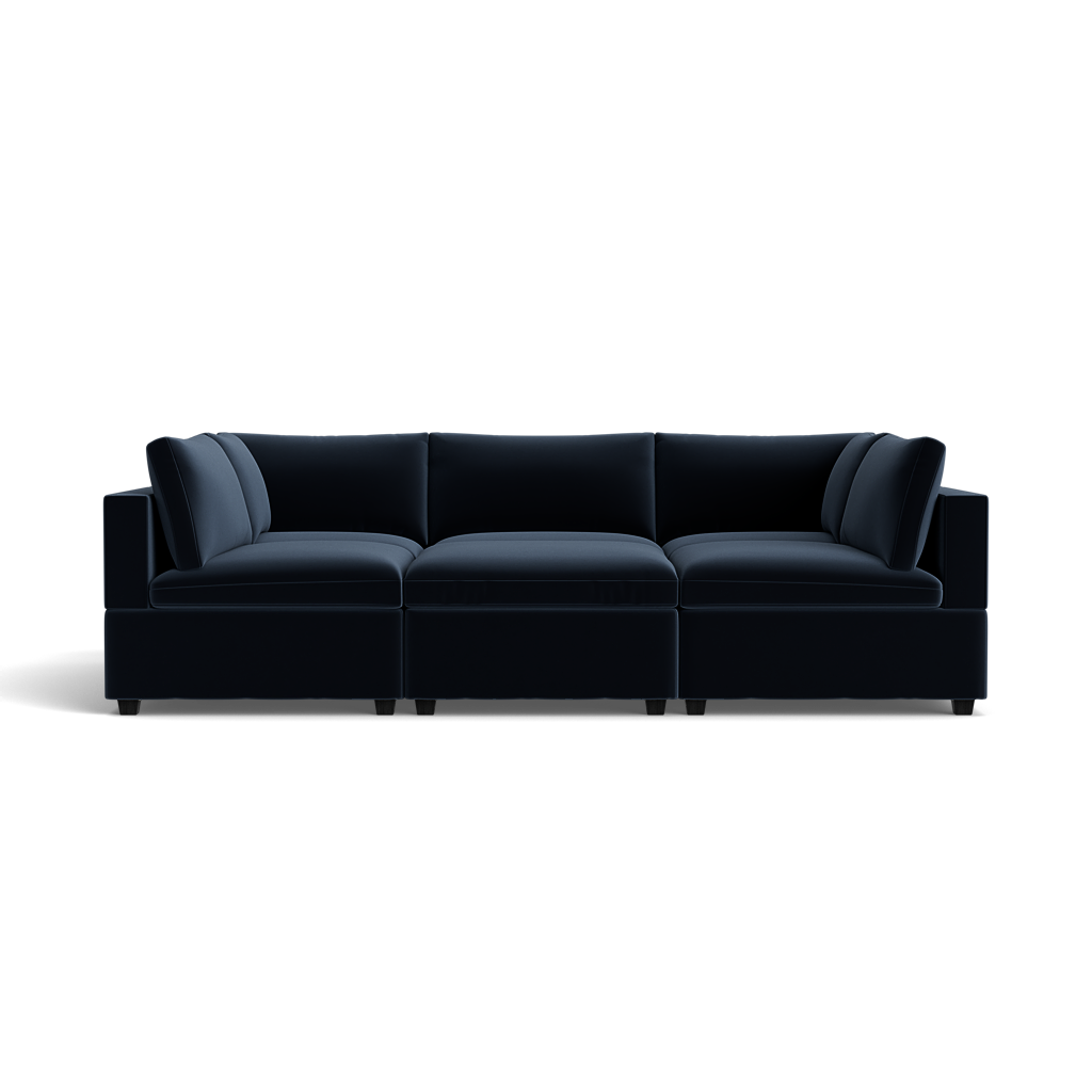 The Kova Box Cushion Pit is a modern dark blue sectional sofa featuring plush cushions and clean lines, shown from the front against a plain black background.