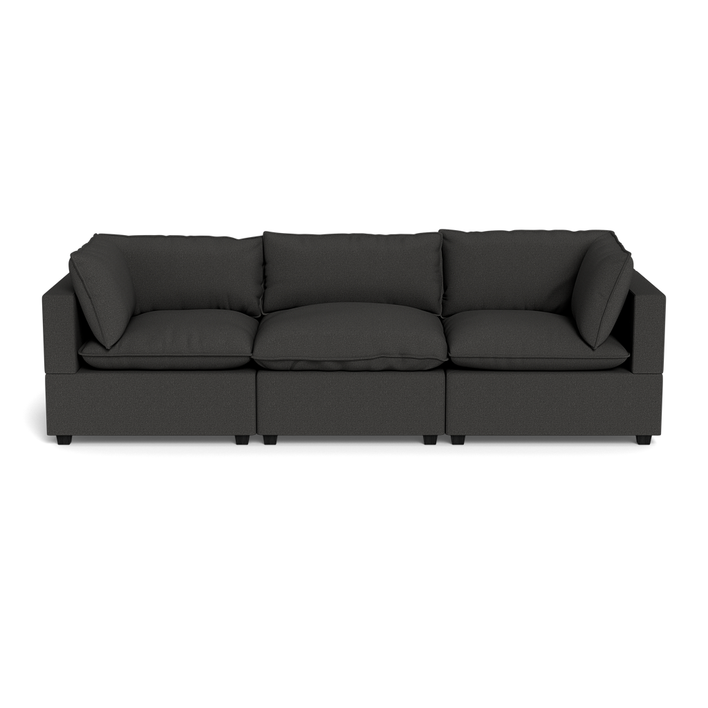 The Kova Pillow Cushion Sofa 122" is a modern three-seat black sofa with square arms and plush back cushions, shown on a plain black background.