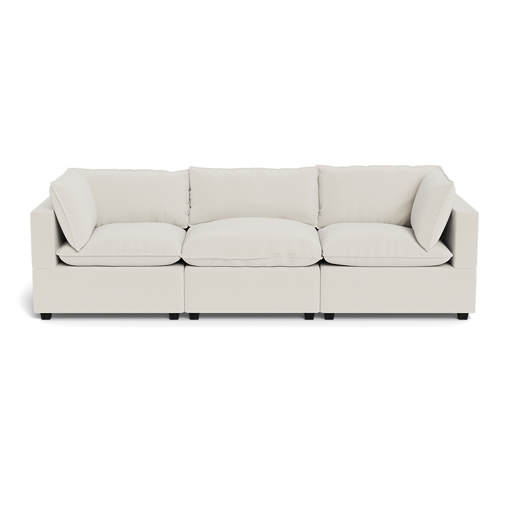 The Kova Pillow Cushion Sofa 122" is a modern beige three-seater with plush cushions and armrests on both sides, shown from the front on a white background.