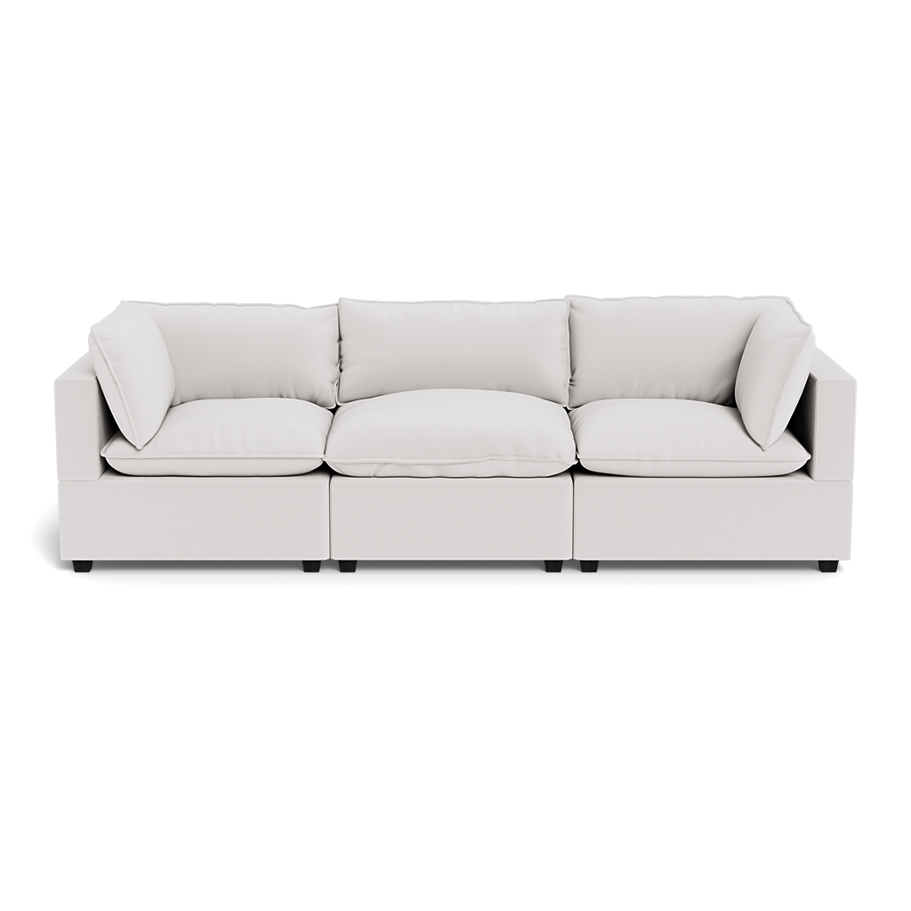 The Kova Pillow Cushion Sofa 122" is a modern, light gray three-seater with wide armrests and five plush back and side cushions, shown from the front against a plain white background.