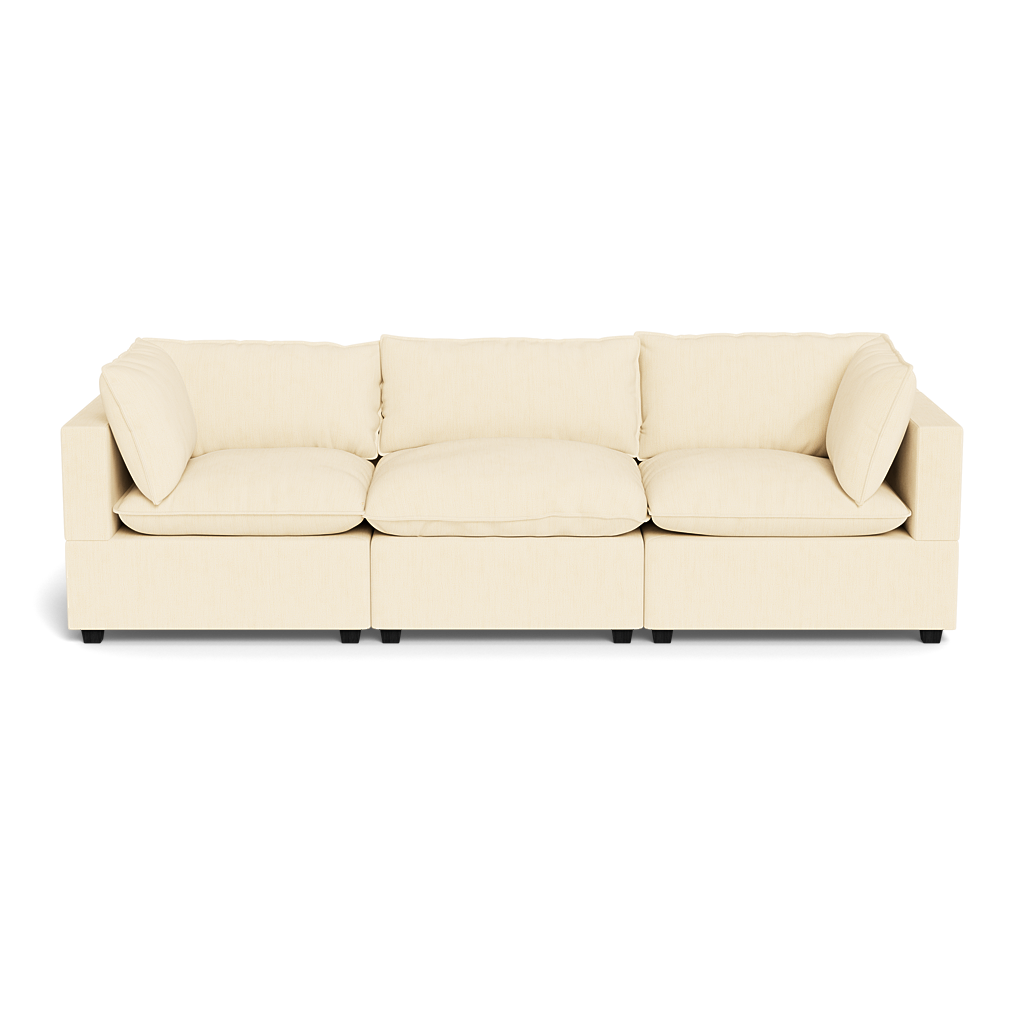 The Kova Pillow Cushion Sofa 122" is a modern, cream-colored three-seater with square arms and back, featuring three seat and back cushions plus two matching pillows, shown against a black background.