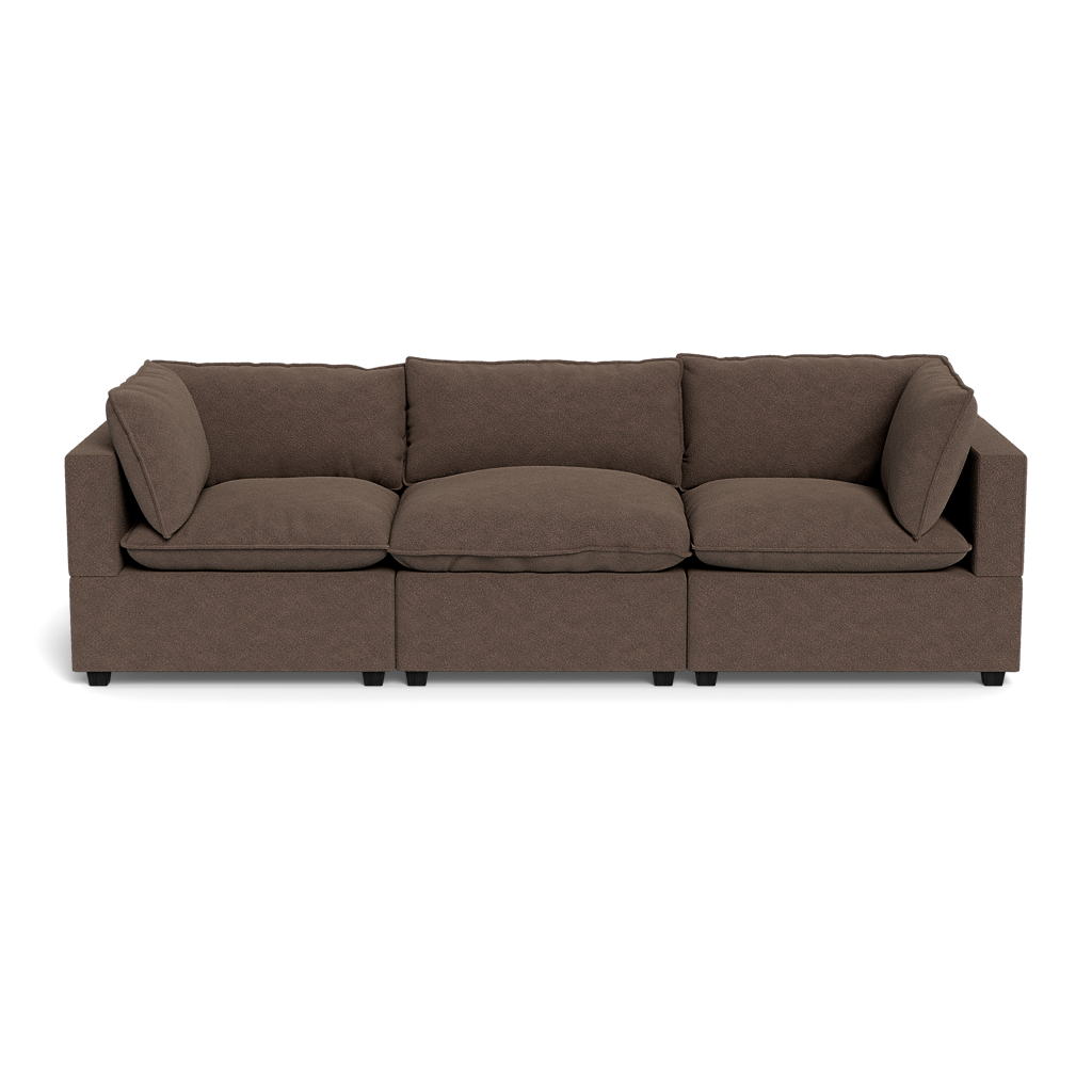 The Kova Pillow Cushion Sofa 122" is a modern, three-seater brown fabric sofa with square armrests and five matching backrest cushions, shown from the front against a black background.