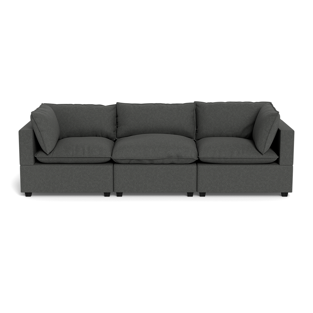 The Kova Pillow Cushion Sofa 122" is a modern, dark gray three-seater with straight arms and back, three seat cushions, and three back cushions, displayed against a black background.