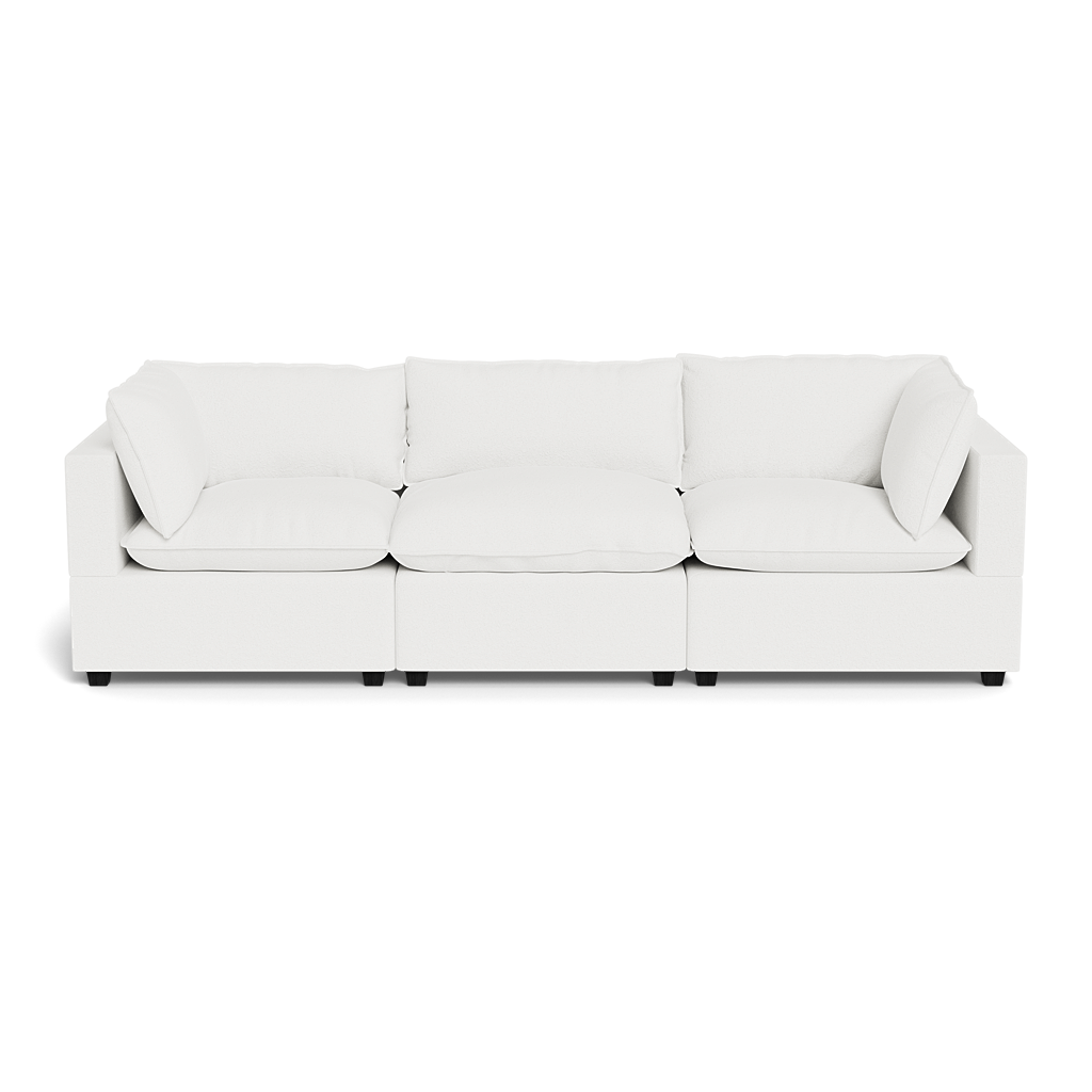 The Kova Pillow Cushion Sofa 122" is a modern, white three-seat sofa with square armrests and back cushions, shown from the front on a plain black background.